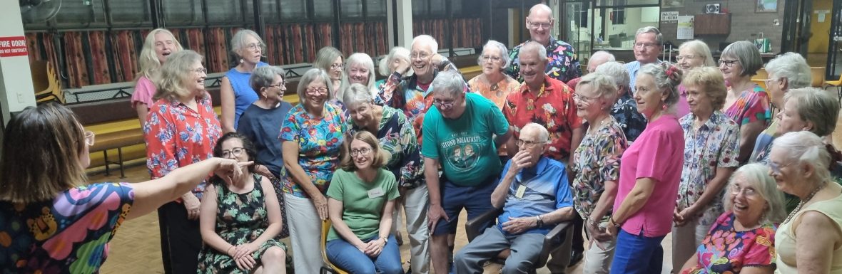 Photograph of choir members singing together.